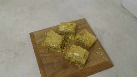 Decorated-pistachio-baklava-pieces-on-wooden-plate