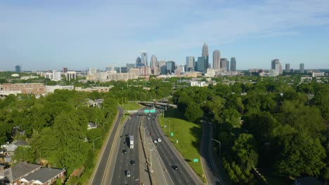 Drone-Flies-Over-Highway-with-Charlotte-Skyline-in-Background