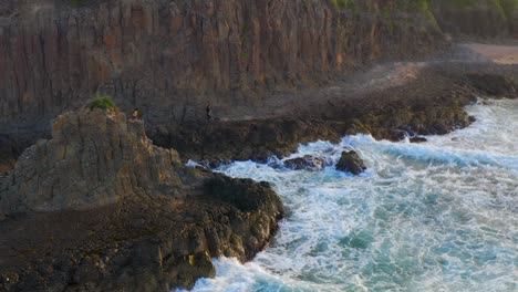 Aerial-view-of-Volcanic-Rocky-shore-with-Waves-Crashing-at-Cathedral-Rocks,-Kiama-Downs,-NSW,-Australia