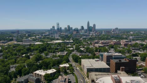 Drone-Flies-Toward-Downtown-Charlotte,-North-Carolina-on-Hot-Summer-Day