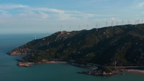 Wind-generators-farm-on-top-of-seaside-mountain-ridge-on-sunny-day