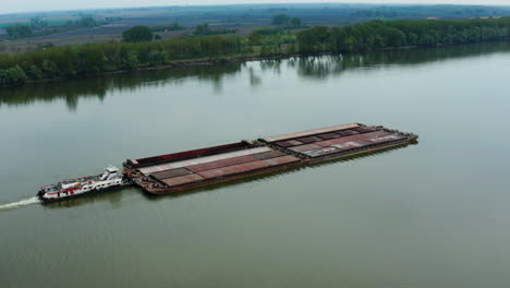Tugboat-Pushing-Barges-On-Danube-River-Passing-Vukovar-City,-Croatia