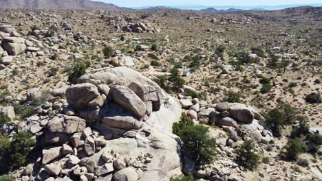 Massive-stone-boulders-in-deserted-terrain-in-orbit-drone-view
