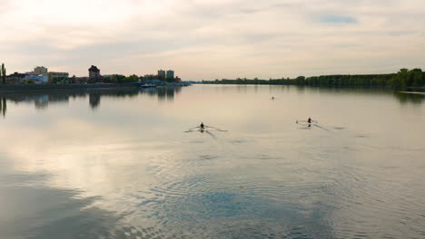 People-rowing-their-boats-and-sees-the-beautiful-sunset-in-Danube-River,-Vukovar-Croatia