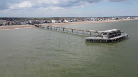Deal-Pier-with-Town-and-beach-in-background-Aerial-Pan-4k