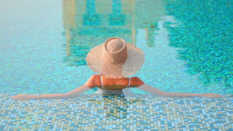 A-close-up-of-a-woman-in-a-swimming-pool-with-her-back-to-the-camera-stretches-out-along-the-edge-of-the-shallow-end-of-the-pool