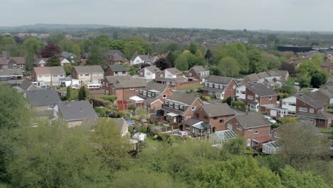 Quiet-British-homes-and-gardens-residential-suburban-property-aerial-view-rising-right-orbit