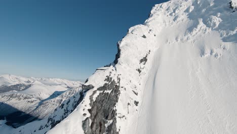 Schneebedeckter-Berggipfel-Erklimmen-Und-In-Der-Fpv-Drohneansicht-Hinunterfliegen