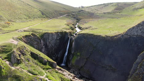 Aerial-of-Spekes-Mill-Mouth-Waterfall,-in-Devon-on-the-UK-coast