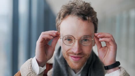 close-up-portrait-Handsome-adult-man-puts-on-glasses