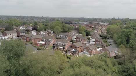 Quiet-British-houses-and-gardens-residential-suburban-property-aerial-view-pan-right-wide