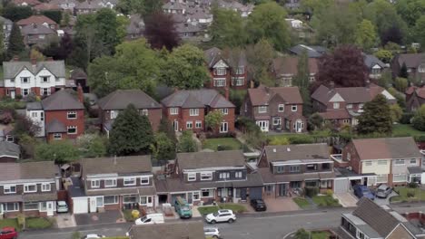 Quiet-British-roads-homes-and-gardens-residential-suburban-property-aerial-rising-right-view-tilt-down