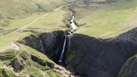Aerial-shot-of-Spekes-Mill-Mouth-Waterfall,-in-Devon-on-the-UK-coast