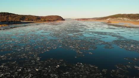Aerial-drone-footage-of-the-Gota-Alv-river-with-frozen-ice-on-top-Sweden