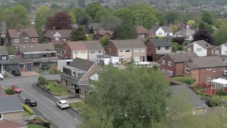 Quiet-British-homes-streets-and-gardens-residential-suburban-property-aerial-view-zoom-out