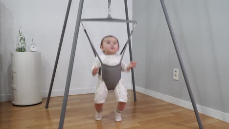The-BEautiful-baby-having-a-great-time-jumping-in-a-special-bouncer-made-from-a-metal-frame-and-hanging-spring