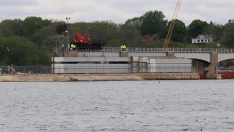 Small-Crew-of-men-using-a-specialized-crane-to-lower-new-dam-rollers-into-Lock-and-Dam-number-14-on-the-Mississippi-River-near-LeClair-Iowa