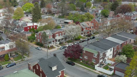 Descending-aerial-establishing-shot-of-homes-in-city
