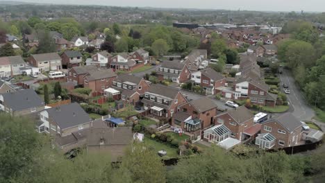Quiet-British-homes-and-gardens-residential-suburban-property-aerial-view-slow-dolly-right