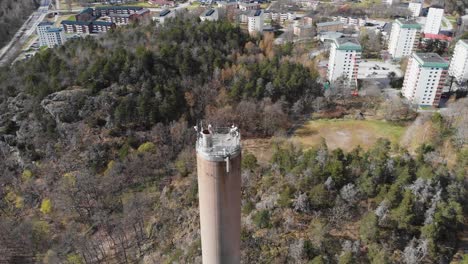 Aerial-Shot-Of-A-Heating-Plant-Chimney-Smoke-Stack-And-Small-City-In-Sweden