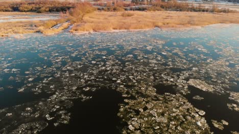 Aerial-Landscape-Scene-Of-Broken-Ice-On-A-Melting-Lake-Outside-Gothenburg,-Sweden