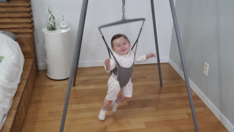 Baby-Mädchen-Springen-Von-Seite-Zu-Seite-Lächelnd-In-Einem-Lustigen-Pullover-Baby-Übungsgeräte