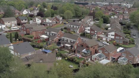 Quiet-British-homes-and-gardens-residential-suburban-property-aerial-view-zoom-out