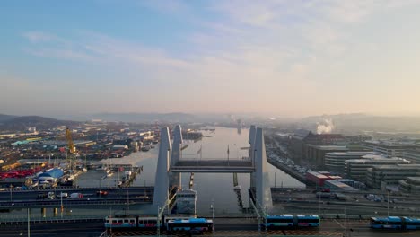 Aerial-View-Of-Trams-Crossing-Gotaalvbron-Next-To-Hisingsbron-Bridge-In-Gothenburg,-Sweden