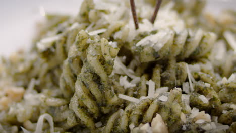Pesto-fusilli-with-grated-cheese,-close-up,-Mediterranean