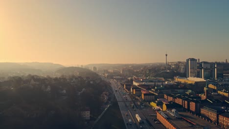 Traffic-At-Highway-E6-Southbound-With-Gothia-Tower-And-Liseberg-Amusement-Park-In-The-Background-At-Sunrise-In-Gothenburg,-Sweden