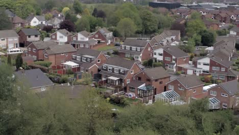 Quiet-British-homes-and-gardens-residential-suburban-property-aerial-view-closeup-orbit-left