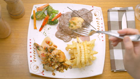 Meat-in-sauce,-prawns,-French-fries-and-salad,-Mediterranean