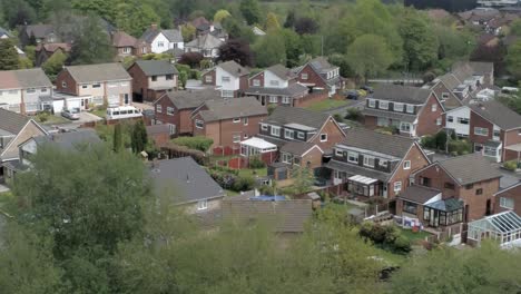 Quiet-British-homes-and-gardens-residential-suburban-property-aerial-view-pull-back-right