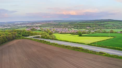 Aerial-shot-of-fields-and-woods-and-hills-in-Barnsley,-North-England