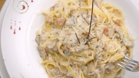 Spaghetti-in-mushroom-sauce-with-grated-cheese,-close-up,-Mediterranean