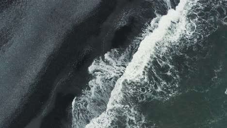 Rising-from-mythical-dark-sand-beach-on-Iceland-south-shore,-aerial