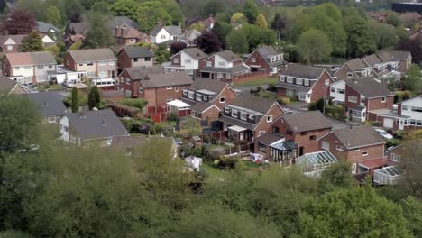 Ruhige-Britische-Häuser-Und-Gärten-Wohnvorort-Eigentum-Luftaufnahme-Dolly-Direkt-über-Bäumen