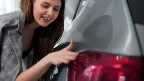 Portrait-of-a-woman-inspecting-a-car-painting