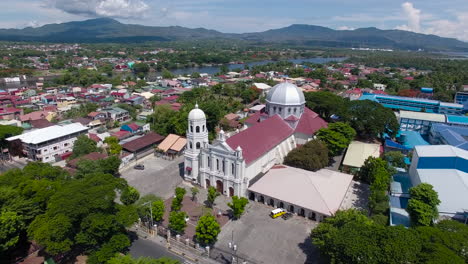 A-Basilica-Church-proud-standing-in-the-valley-of-Batangas,-Philippines,-in-the-A-drone-view