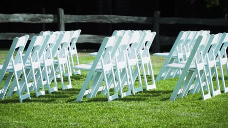 Folding-Chairs-Setting-For-An-Outdoor-Wedding-Event-With-wooden-Fence-In-Background