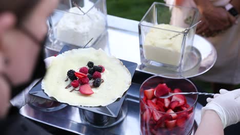 Preparation-of-crepe-with-strawberries-and-berries-served-elegantly