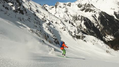 Slow-motion-deep-snow-powder-skiing-in-beautiful-long-ski-turns-with-amazing-alpine-mountain-view