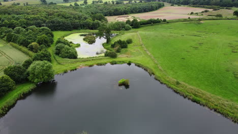 An-aerial-view-of-small-fishing-pools-in-the-Worcestershire-countryside,-ENgland