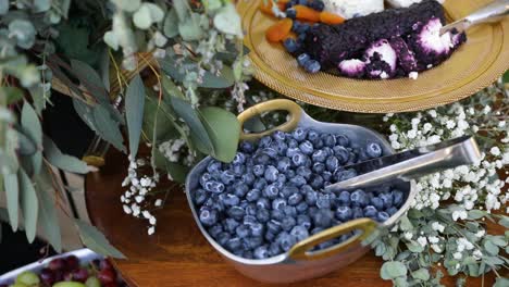 Fancy-fruit-plate-display-with-blueberries-and-floral-decoration