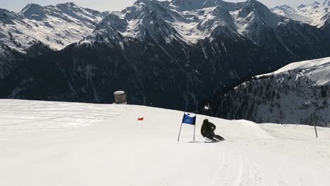 Ski-racing-in-ski-gates-on-a-race-slope-with-unbelievable-view-over-the-beautiful-mountain-landscape-in-the-alps
