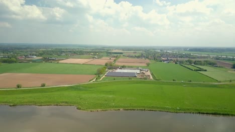 Aerial-drone-view-of-the-beautiful-green-and-flat-countryside-landscape-in-the-Netherlands