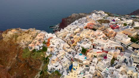 Amazing-video-of-famous-white-and-colourful-picturesque-village-of-Oia-built-on-a-cliff-at-sunset,-Santorini-island,-Cyclades,-Greece