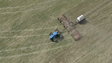 Aerial-View-Of-Farmer-In-Tractor-Seeding