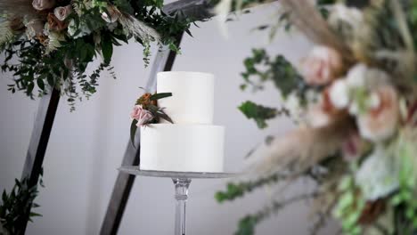 White-Wedding-Cake-With-Flowers---selective-focus
