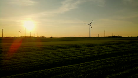 Sunset-Landscape-scenery-with-offshore-windmills-farm,-filmed-from-a-drone-perspective